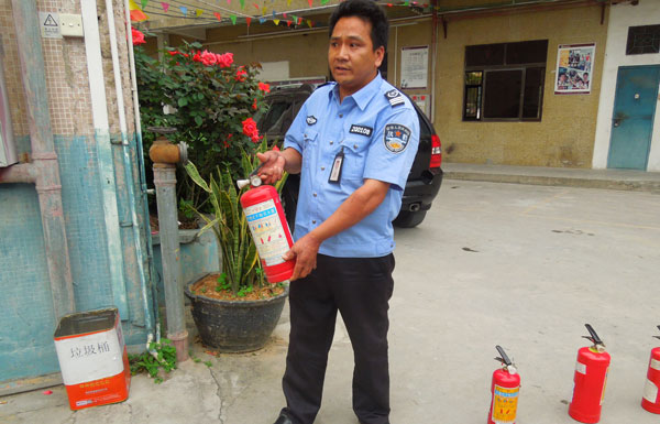 The leader of the security team, Wande Chen, demonstrate the use of fire extinguishers.